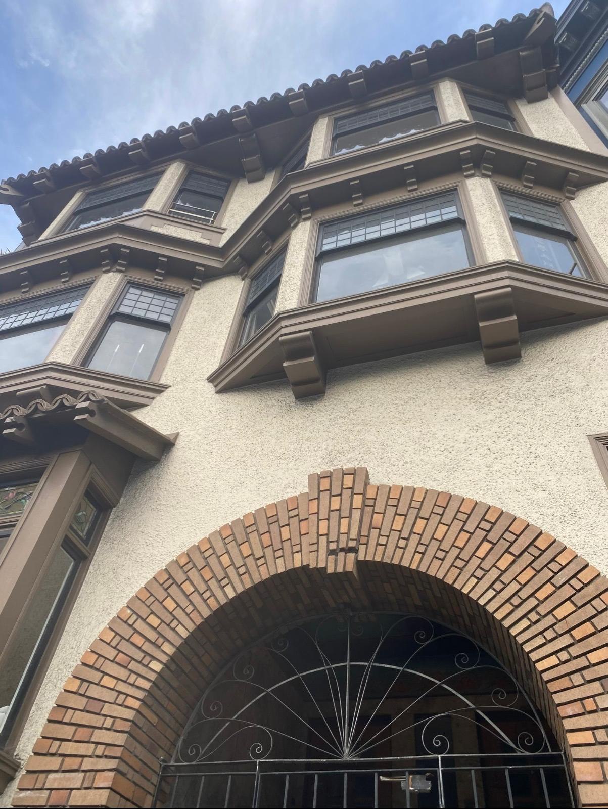 Finished historic exterior with restored brown trim and detailed bay windows
