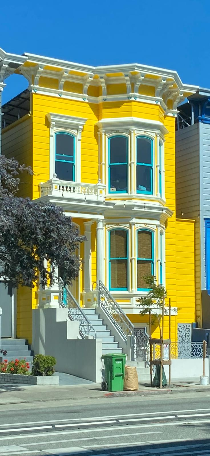 Bright yellow Victorian exterior painting project on Valencia Street in San Francisco